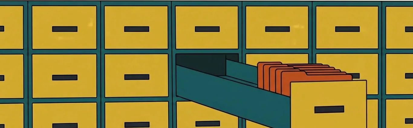 A wall of filing cabinet drawers with one drawer pulled open to show its files